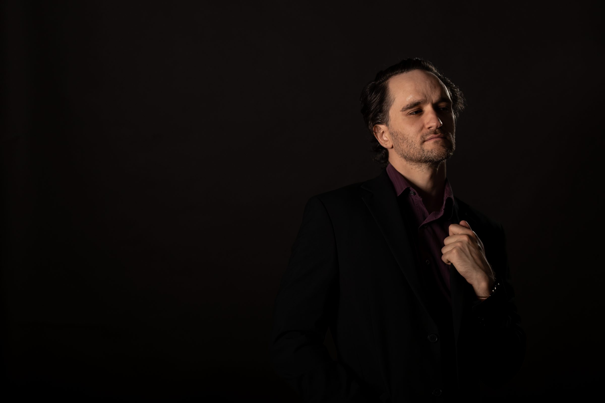 Jacques du Plessis, photographed in low light against a dark background